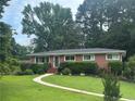 Traditional brick home featuring a well-kept lawn and manicured landscaping at 388 Talcott Nw Cir, Marietta, GA 30064