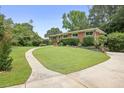 Beautiful one story brick home with a lush green lawn, nice landscaping, and a curved walkway at 388 Talcott Nw Cir, Marietta, GA 30064