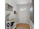 Cozy hallway with a light-colored console table, wooden floors, and decorative artwork at 388 Talcott Nw Cir, Marietta, GA 30064