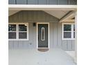 Welcoming front porch with stylish door and white framed windows, offering curb appeal and inviting entry at 487 Eastside Dr, Dacula, GA 30019