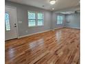 Bright living room features gleaming hardwood floors and ample natural light, perfect for gatherings at 487 Eastside Dr, Dacula, GA 30019