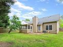 Large, grassy backyard with a screened-in porch and mature trees, perfect for outdoor living at 1615 Nw Vinebrook Nw Ter, Kennesaw, GA 30144