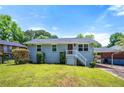 Charming single Gathering home with well-maintained lawn, landscaping, and covered parking at 1985 Thomasville Se Dr, Atlanta, GA 30315