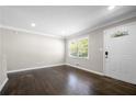 Bright living room with decorative trim, hardwood floors and natural light from large windows at 1985 Thomasville Se Dr, Atlanta, GA 30315