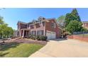 Charming two-story brick home with a two-car garage and a well-maintained lawn at 4541 Meadow Club Dr, Suwanee, GA 30024