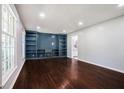 Spacious living room with hardwood floors and built-in bookshelves at 1663 Pounds Sw Rd, Stone Mountain, GA 30087