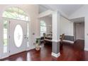 Inviting foyer showcasing hardwood floors, high ceilings, elegant columns, and an arched window above the door at 408 Gray Fox Dr, Canton, GA 30114