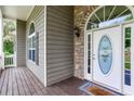 Close-up of the front entrance featuring a decorative glass door, stone accents, and a covered porch area at 408 Gray Fox Dr, Canton, GA 30114