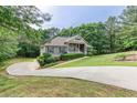 Long driveway leading to a well-maintained single-story home with mature trees in a quiet neighborhood setting at 408 Gray Fox Dr, Canton, GA 30114