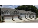 New construction townhomes featuring attached garages and modern color scheme with sidewalks at 5004 Elowen Ln, Douglasville, GA 30135