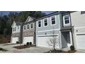 New townhome exterior featuring attached garages and modern gray color scheme with many windows at 5004 Elowen Ln, Douglasville, GA 30135