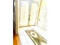 Foyer with white tile floors and decorative rug leading to the front door, framed by white columns at 5430 Lemoyne Sw Dr, Atlanta, GA 30331