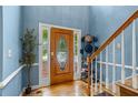 Inviting entryway featuring hardwood floors, stylish front door, and a convenient coat rack at 134 Waterloch Ct, Lawrenceville, GA 30043