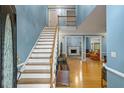 Light-filled foyer with hardwood floors, staircase, and views into the living area at 134 Waterloch Ct, Lawrenceville, GA 30043