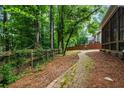 Landscaped backyard featuring a stone path, privacy fence, and lush greenery at 1772 Benningfield Sw Dr, Marietta, GA 30064