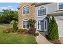 Close-up view of a home's exterior, showcasing the stone facade, front door, and landscaping at 2261 Seatton Ct, Marietta, GA 30062