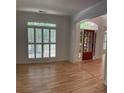 Bright living room featuring hardwood floors, shuttered windows, and an arched doorway at 753 Hayes Ct, Atlanta, GA 30349