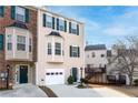 Charming townhome featuring a bay window, green shutters, and a one-car garage at 805 Abbotts Mill Ct # 74, Duluth, GA 30097