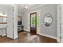 Elegant foyer with hardwood floors, stylish lighting, and convenient access to a half bathroom at 1104 Victoria Ne St, Brookhaven, GA 30319