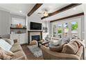 Cozy living room featuring a fireplace, built-in cabinets, and french doors to the backyard at 1104 Victoria Ne St, Brookhaven, GA 30319