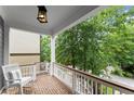 Inviting porch with rocking chair, featuring brick flooring and lush greenery views at 1104 Victoria Ne St, Brookhaven, GA 30319