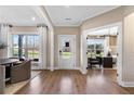 Bright foyer featuring hardwood floors, large windows, and an adjacent home office at 5360 Hyde Rd, Cumming, GA 30040