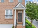 Inviting front entrance with decorative pillars, a charming light fixture, and a well-maintained brick facade at 6054 China Rose Ln, Duluth, GA 30097