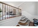 Elegant staircase featuring dark wood steps, white risers, and iron balusters, leading to the upper level at 6054 China Rose Ln, Duluth, GA 30097