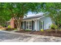Exterior of a cozy home with light blue siding, black shutters, and mature trees at 1141 Moorestown Cir, Decatur, GA 30033