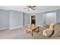 Spacious living room featuring neutral walls, carpet, and a view into the dining area at 122 Rue Fontaine, Lithonia, GA 30038