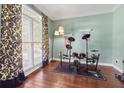 Comfortable room featuring a drum set, hardwood floors, and a large window at 2015 Towne Lake W Hls, Woodstock, GA 30189