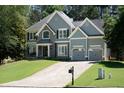 Beautiful two-story home with a two-car garage and well maintained lawn at 2015 Towne Lake W Hls, Woodstock, GA 30189