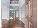 Stunning two-story foyer with hardwood floors and an open staircase offers a grand entrance at 3313 Alhambra Cir, Hampton, GA 30228
