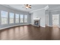 Bright living room with fireplace, tray ceiling, and large windows offering natural light at 3313 Alhambra Cir, Hampton, GA 30228