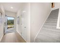 Bright entryway leads to staircase with plush carpeting and views of outdoors at 1017 Merritt Dr # 103, Villa Rica, GA 30180