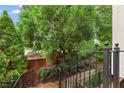 Inviting brick pathway with wrought iron railings leading to the entrance of the home at 4298 Kingston Gate Cv, Chamblee, GA 30341
