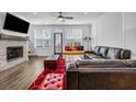 Bright living room with stone fireplace, hardwood floors, and modern decor accents at 4565 Sims Park Ovlk, Suwanee, GA 30024