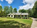 Inviting one-story home with a well-kept lawn, accented by lush landscaping at 350 Lakeview Dr, Brooks, GA 30205