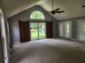 Bright living room with vaulted ceiling, large window, and stylish barn door at 350 Lakeview Dr, Brooks, GA 30205