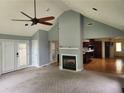 Open living space featuring a fireplace and hardwood floors, with views into the kitchen at 350 Lakeview Dr, Brooks, GA 30205