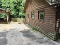 Exterior of a rustic cabin with a long driveway surrounded by trees at 418 Honey Suckle Ln, Stockbridge, GA 30281