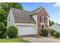 Inviting home with attached garage, brick accents, and a manicured lawn at 4305 Chesapeake Trce, Acworth, GA 30101