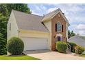 Charming two-story home with brick facade, manicured landscaping, and attached two-car garage at 4305 Chesapeake Trce, Acworth, GA 30101