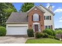 Well-maintained two-story home with brick and siding, featuring an attached garage and landscaped front yard at 4305 Chesapeake Trce, Acworth, GA 30101
