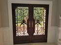 Detailed wrought iron double front door provides a grand entry to the home at 45 Mountain Crest Dr, Oxford, GA 30054