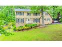 Charming two-story home featuring brick and vinyl siding, well-kept lawn, and mature trees at 5293 Sandy Shoals Ln, Stone Mountain, GA 30087