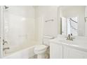Bathroom with a tub and shower combo, white vanity, and a large mirror at 765 Brooks Cir, Stone Mountain, GA 30087