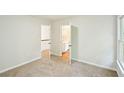 A neutrally decorated bedroom showing the door to the bathroom at 765 Brooks Cir, Stone Mountain, GA 30087