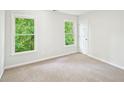 This bedroom features neutral carpet, natural light, and a standard closet at 765 Brooks Cir, Stone Mountain, GA 30087