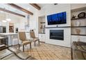 Spacious living room boasts beamed ceilings, fireplace, and built-in shelving at 114 Village Green Ave, Woodstock, GA 30189